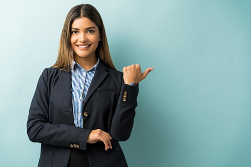 hispanic female executive gesturing copy space while making eye contact studio 1